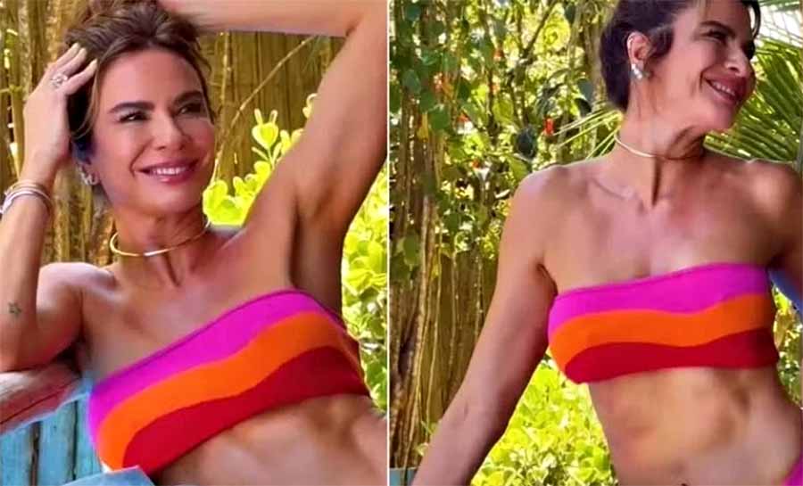 Luciana Gimenez posa de biquíni rosa e laranja ao sol e web reage